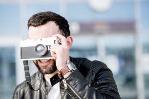 Man with photo camera outdoors