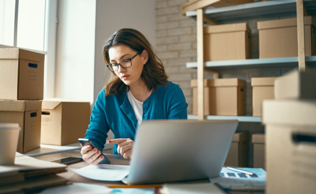 Woman is working at warehouse for online store.