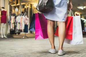 Young woman with shopping bags in the shop